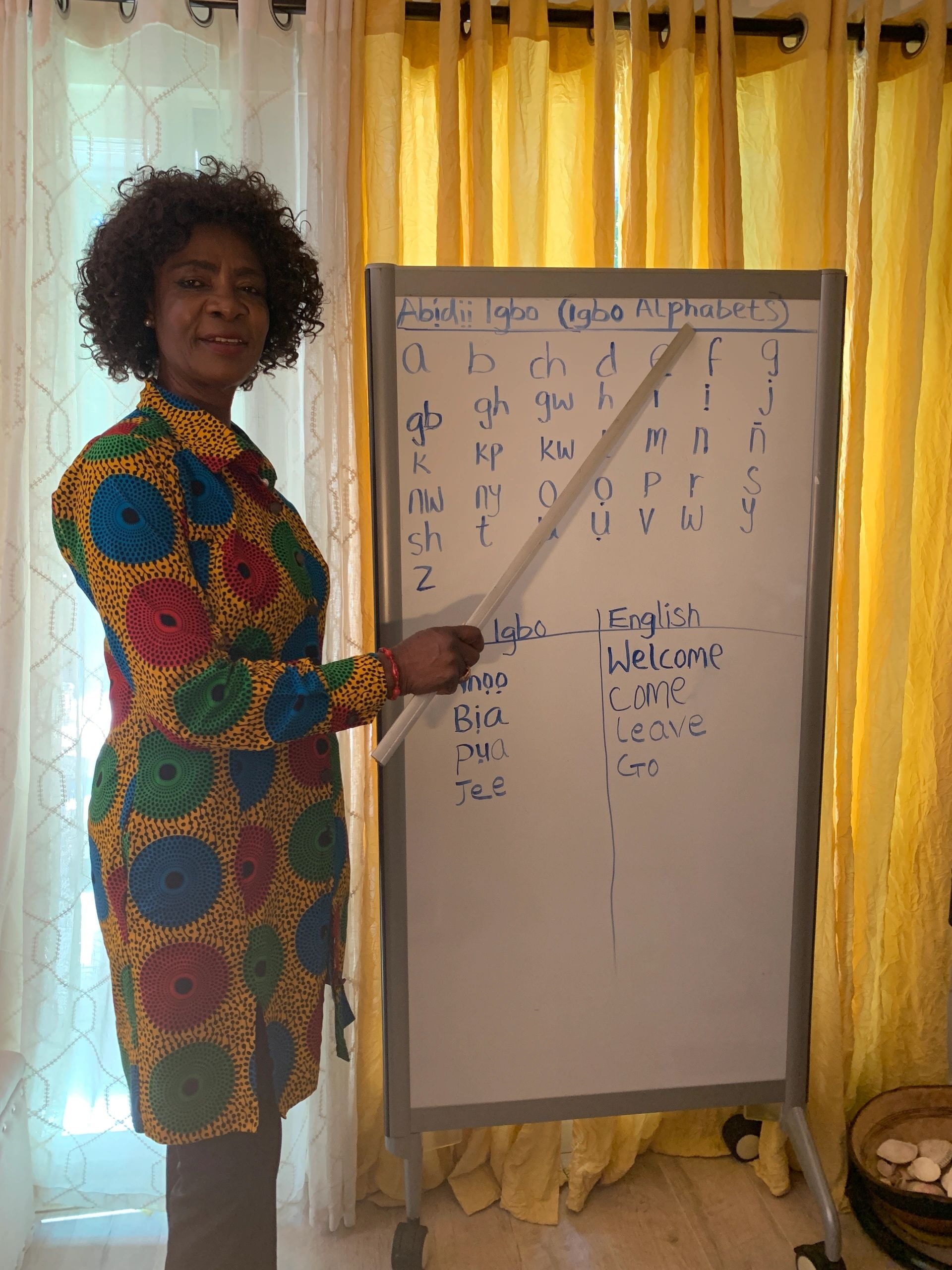 Anthonia teaching Igbo language at a whiteboard